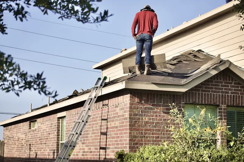 Professional roofer working on a residential roof in Old Colton